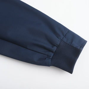Detail of jacket buttons and pocket on Diplomat Harrington coat
