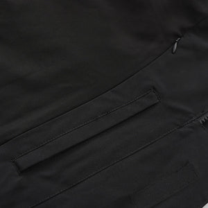 Jacket collar and closure detail with protective layering visible